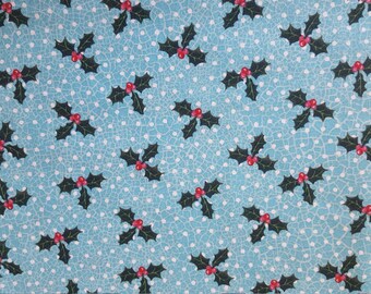 May include: A repeating pattern of holly leaves and red berries on a light blue background with white polka dots. The holly leaves are dark green, and the berries are a bright red. The pattern is a festive design.