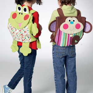 May include: Two children wearing colorful backpacks with animal designs. The girl's backpack is green and features a frog with a pink tongue. The boy's backpack is brown and features a monkey with pink cheeks. Both backpacks have a striped pocket on the front.