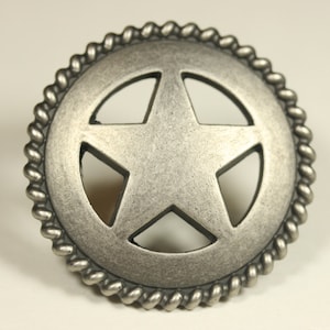 May include: A silver-toned metal star-shaped button with a rope-like border. The star is cut out, revealing the metal underneath.