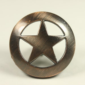 May include: A copper-toned metal star-shaped knob with a five-pointed star cutout in the center. The knob has a brushed finish.