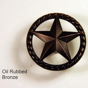May include: Oil rubbed bronze cabinet knob with a five-pointed star design in a rope-like circle.