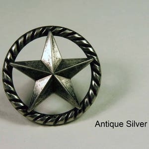 May include: Antique silver star-shaped knob with a rope-like border.  Antique Silver.