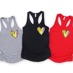 May include: Three tank tops with a softball design in the shape of a heart. The tank tops are in grey, black, and red.