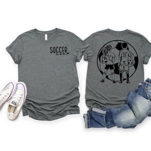May include: Two gray t-shirts with a black soccer design on the back. The design features two soccer players, a girl and a boy, standing in front of a soccer ball. The girl's shirt says "Kylie 1" and the boy's shirt says "Caleb 21". The front of the gray t-shirt says "Soccer Mom" in black text.
