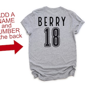 May include: Gray t-shirt with the text "BERRY 18" printed on the back in black.