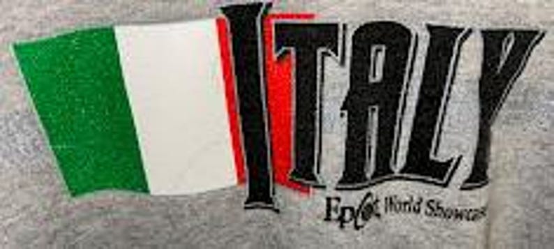 May include: A gray graphic featuring the word "ITALY" in black, with a waving Italian flag in green, white, and red. Below the word "ITALY" is the text "Epcot World Showcase".