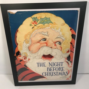 May include: A vintage framed print of a smiling Santa Claus with a red and black striped scarf. The print is titled "The Night Before Christmas".