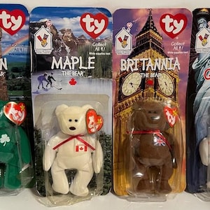 May include: Four Ty Beanie Baby bears: Erin the green bear with a shamrock, Maple the white bear with a Canadian flag, Britannia the brown bear with a Union Jack, and Glory the white bear with stars and an American flag.