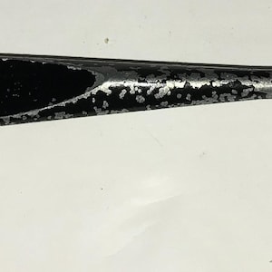 May include: A vintage glass cutter with a silver finish and a black handle. The tool has a cutting head with multiple teeth and the text "MADE IN U.S.A."