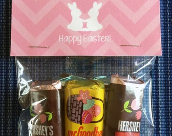 May include: A pink and white card with the text "Happy Easter!" and two bunny silhouettes. The card is in a clear plastic bag with three chocolate bars: Hershey's Special Dark, Mr. Goodbar milk chocolate with peanuts, and another Hershey's Special Dark.