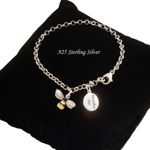 May include: .925 sterling silver chain bracelet featuring a bee charm with yellow and black stripes and clear stones on the wings, alongside a round silver tag engraved with the text Any Engraving, secured with a lobster claw clasp.