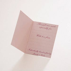 May include: A light pink folded gift card featuring dark pink cursive text that reads: This gift was made especially for, With love from, and Individually handcrafted by Jewels 4 Girls, with dotted lines for writing names and messages.