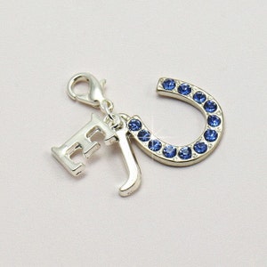 Silver plated something blue charm on a lobster clasp, featuring 2 letter charms, one for the bride and one for the groom along with a blue crystal heart charm