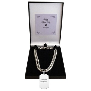 May include: A silver chain necklace with a silver dog tag pendant that says "This Dad Belongs to..." The necklace is in a black gift box with a white card that says "Happy Father's Day" and "With Love".