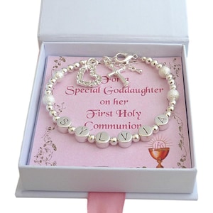 Stunning bracelet for a girls First Holy Communion, any name can be added in letters beads, Silver plated large sparkle beads and smaller round silver beads. Featuring a cross and sparkling open heart charms by the clasp