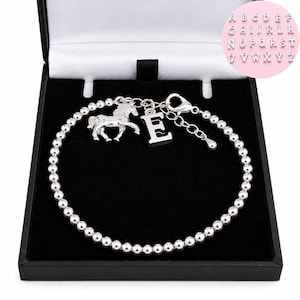 May include: A silver-toned beaded bracelet featuring a horse charm and a letter E charm. The bracelet includes a lobster claw clasp and an adjustable chain extension. A circular chart in the top right corner displays the full alphabet in silver letters.