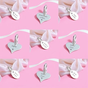 May include: A collection of silver-toned metal charms in heart and oval shapes, each featuring a jump ring and custom engravings including phrases like Special Bridesmaid, Sophie, Mother of the Bride, and Happy Birthday with small heart icons.