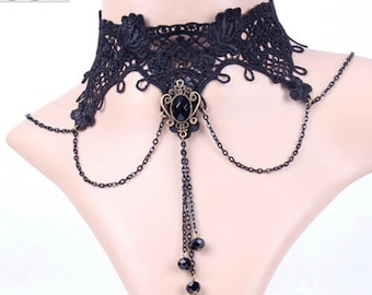 May include: Black lace choker necklace with a floral design. The necklace features a central pendant with a black stone and dangling chain with black beads. The choker is displayed on a mannequin.