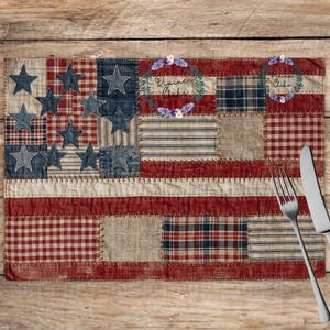 May include: A patriotic placemat with a patchwork design resembling the American flag. The placemat features red, white, and blue fabrics with stars and stripes. A fork and knife are placed on the wooden surface.