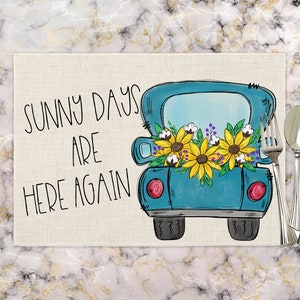 May include: A blue pickup truck with a bed full of sunflowers and cotton bolls. The truck is on a beige background with the text "Sunny days are here again".