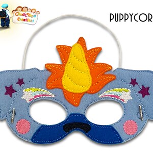 May include: A blue felt unicorn puppycorn mask with a yellow horn, orange mane, and rainbow embroidered details. The mask has two pink circles and two purple stars on the sides. The mask has an elastic band for wearing.
