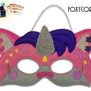May include: Pink felt unicorn mask with a silver glitter horn, purple mane, and gray face. The mask has a white elastic band for wearing.
