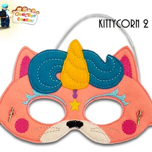 May include: Pink felt cat mask with a blue and yellow unicorn horn, a star, and pink accents. The mask has elastic straps for wearing. "KITTYCORN 2" is written in the top right corner.