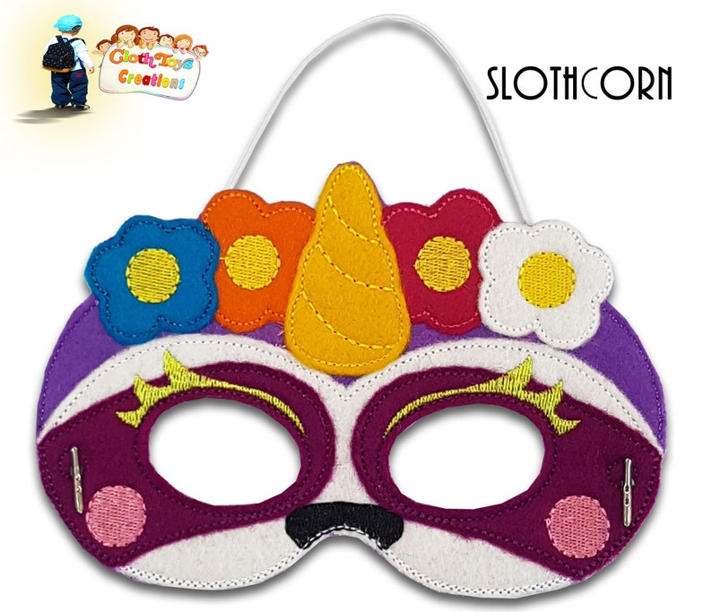 May include: Purple and white felt slothcorn mask with a yellow horn and colorful flowers. The mask has a white elastic band for wearing.