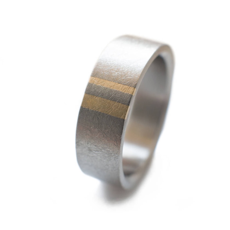 Titanium Mens wedding band with two subtle gold inlays.