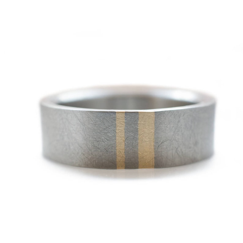 Titanium Mens wedding band with two subtle gold inlays.