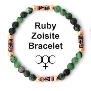 May include: A green and black gemstone bracelet with copper beads and a copper clasp. The bracelet has the text "Ruby Zoisite Bracelet" and the symbol for the zodiac sign Libra.