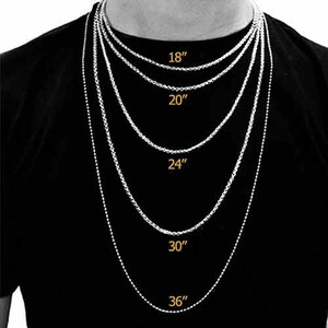 May include: A silver chain necklace in five different lengths: 18 inches, 20 inches, 24 inches, 30 inches, and 36 inches.