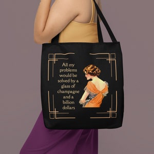 May include: Black tote bag with a gold border and text that reads "All my problems would be solved by a glass of champagne and a billion dollars". A vintage illustration of a woman in a dress is featured on the bag.