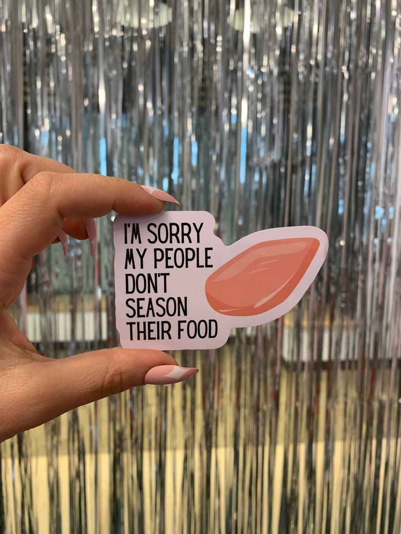 May include: A white sticker with black text that reads "I'm sorry my people don't season their food." A pink meat cut-out is on the right side of the sticker.