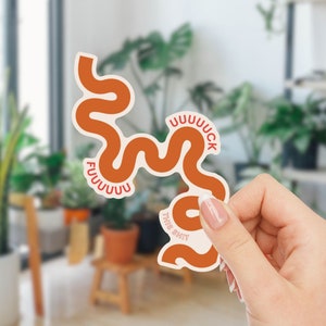 May include: Orange and red sticker with the text "FUUUUUUUCK THIS SHIT" in a wavy, abstract design.