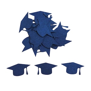 May include: A collection of navy blue graduation cap cutouts, with a tassel hanging from each cap. Some caps are scattered in a pile, while three are neatly arranged below. The caps are made of a textured material.