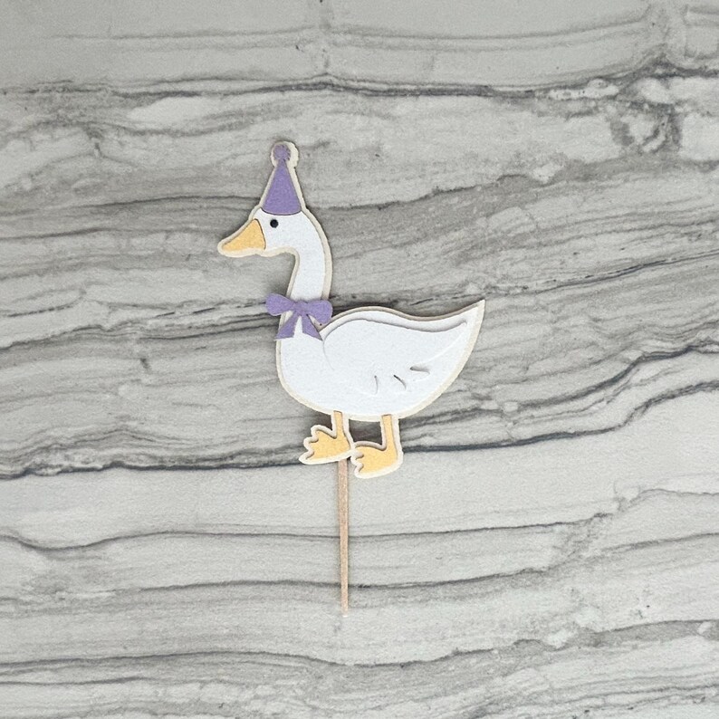 Goose cupcake topper shown in light purple accent color.