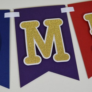 May include: Purple and red felt banner with gold glitter letters spelling "MOM".