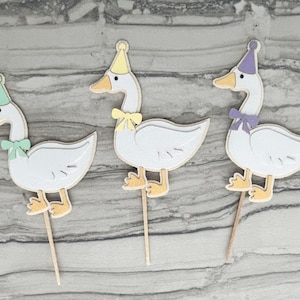 Three goose cupcake toppers shown in mint green, yellow, and light purple accent color options.