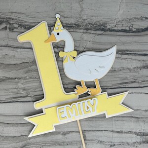 First birthday cake topper with a goose and personalized with the name Emily.  Shown in the yellow accent color.