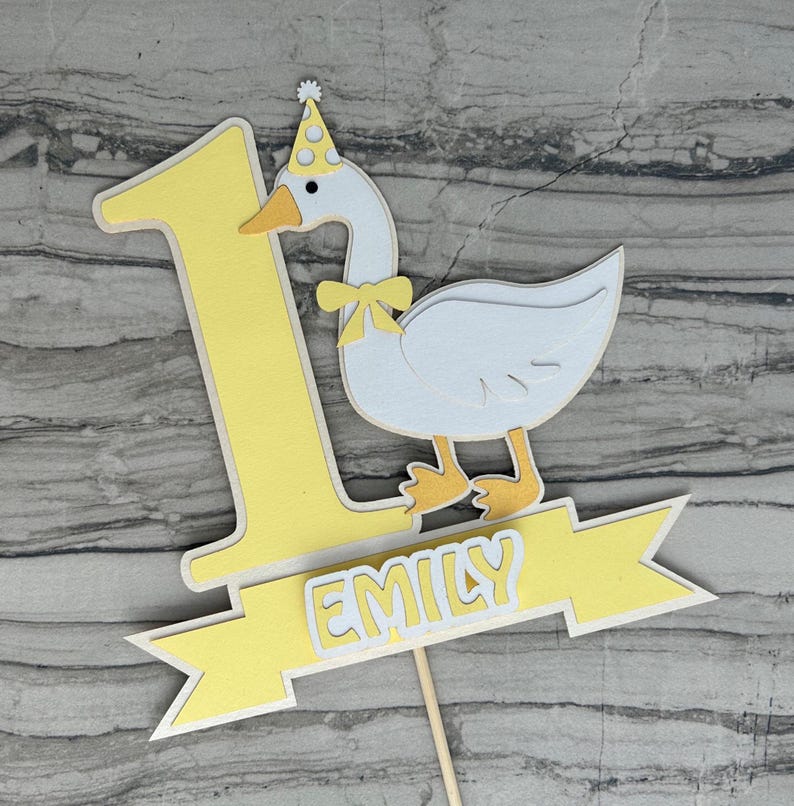 First birthday cake topper with a goose and personalized with the name Emily.  Shown in the yellow accent color.