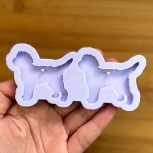 May include: A set of three ceramic mugs with a speckled, matte finish. The mugs are in shades of cream, light gray, and dark gray. Each mug has a simple, minimalist design, perfect for coffee or tea.