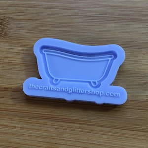 Puede incluir: Un molde de silicona morado con forma de bañera con el texto "thecraftsandglittershop.com" en la parte inferior.
