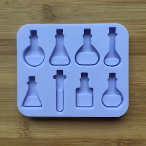 May include: A purple silicone mold with eight different shapes of bottles and test tubes. The mold is designed for making resin crafts.