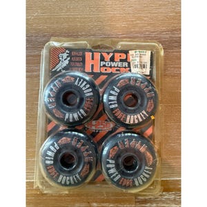 May include: A set of four black Hyper Power Edge Hockey inline skate wheels. The wheels have orange and white text that reads "Hyper Power Edge Hockey". The packaging reads "New Hlook Hub Design for Stability Longer Wear".