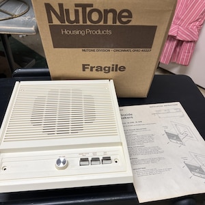 May include: A beige NuTone intercom system with a speaker grill, volume knob, and buttons. The box behind it reads "NuTone Housing Products" and "Fragile". Installation instructions are visible.