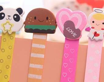 May include: Set of five colourful wooden bookmarks with different designs. The bookmarks feature a panda, a hamburger, a heart with the word "LOVE", an angel, and a striped pattern.