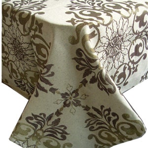 May include: A beige tablecloth with a brown and gold damask pattern. The tablecloth has a square shape and is made of a woven fabric.