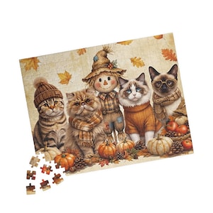 May include: A rectangular jigsaw puzzle featuring an autumn scene with four cats and a scarecrow. The cats wear hats, scarves, and glasses. The scene includes pumpkins, pinecones, and falling orange leaves. Several loose puzzle pieces are below.
