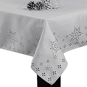 May include: A white tablecloth with a snowflake design. The tablecloth has a subtle sheen and is made of a lightweight fabric.